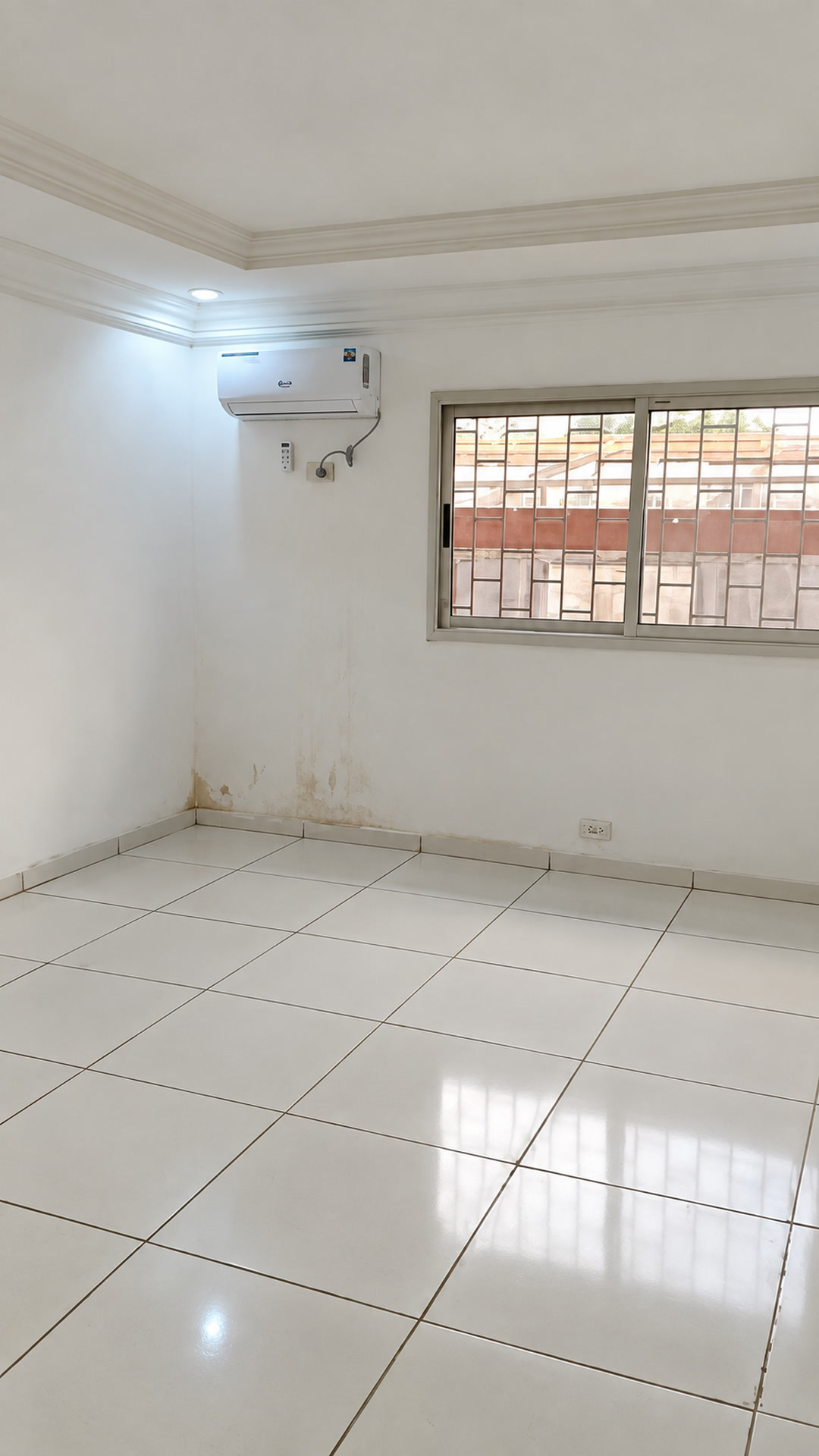 Unfurnished tiled room with a window and ceiling detail; Enhanced rendition of the owner’s video still