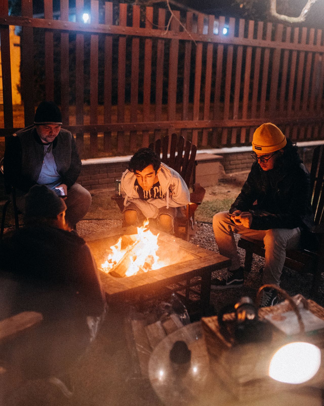 Sample stock photo of friends around a campfire, not a past Nelson & Associates event